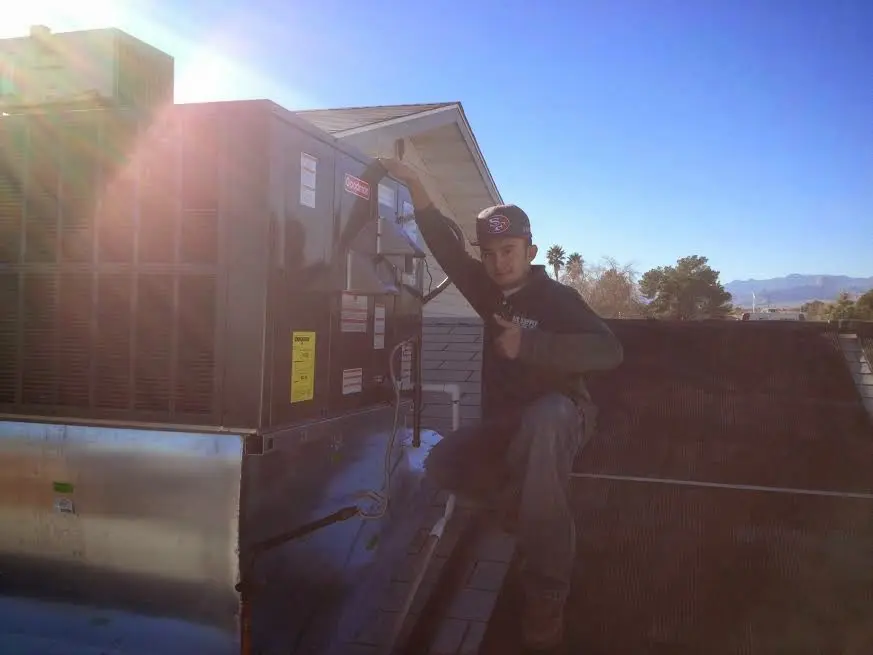 HVAC technician performing HVAC Inspection on a rooftop unit in West Rancho Dominguez